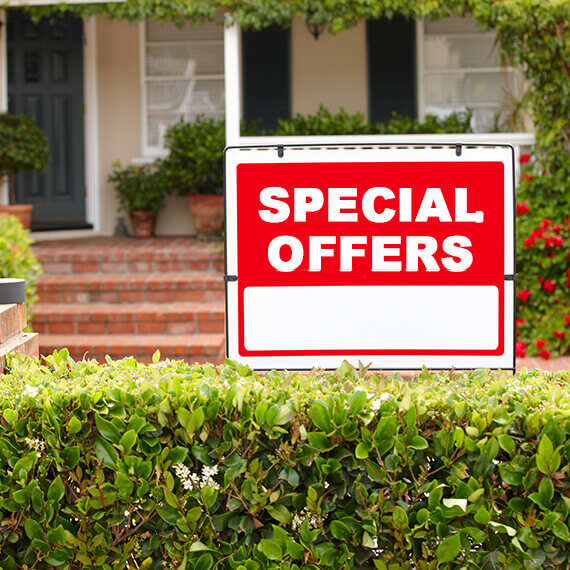 red for sale sign posted in front of residential house