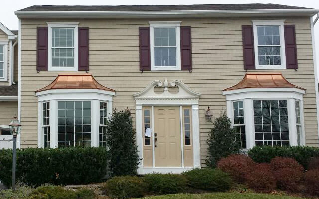 brand new white exterior pvc trim, copper roofs, white gutters and vinyl siding.