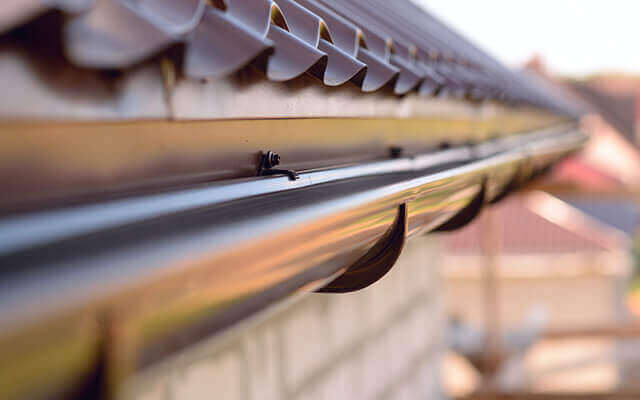 close up of rain gutter system on residential house